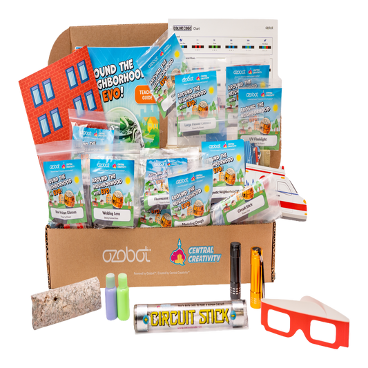 Educational toy kit with various components including a cardboard box labeled 'Central Creativity' and 'Ozobot'.