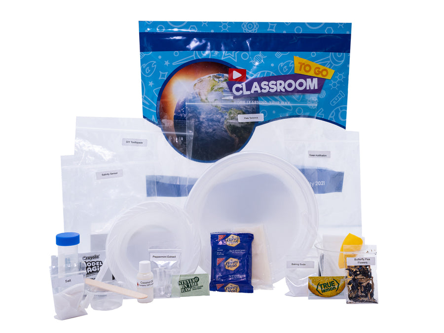 A blue Classroom TO GO earth and space science unit bag with its activity bags laid out in front of it