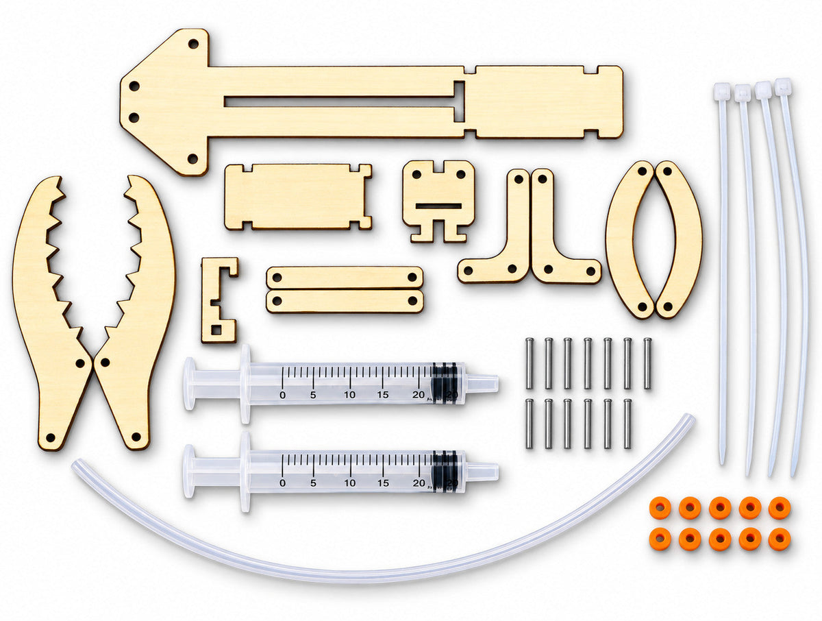 Everything in the kit laid out: laser-cut wooden parts, two syringes, clear hose, metal shafts, orange fixing rings and zip ties