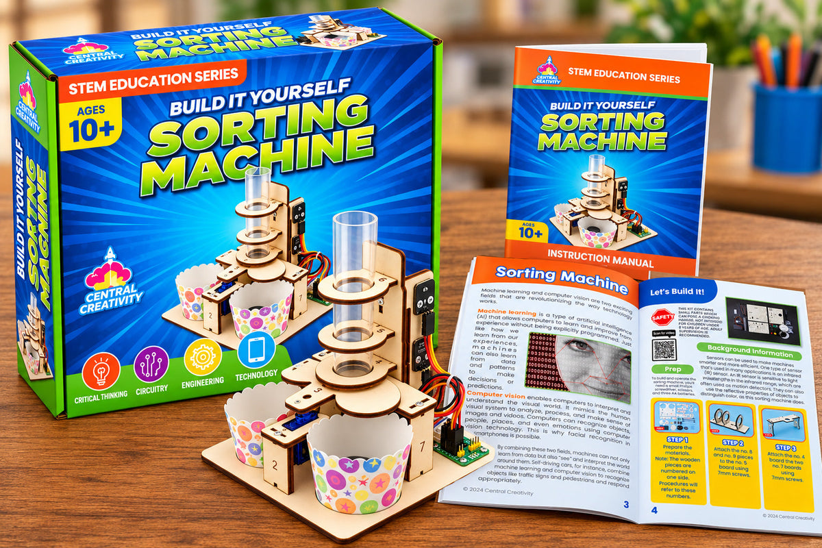 The Sorting Machine Kit box, the built machine and the open instruction manual together on a desk