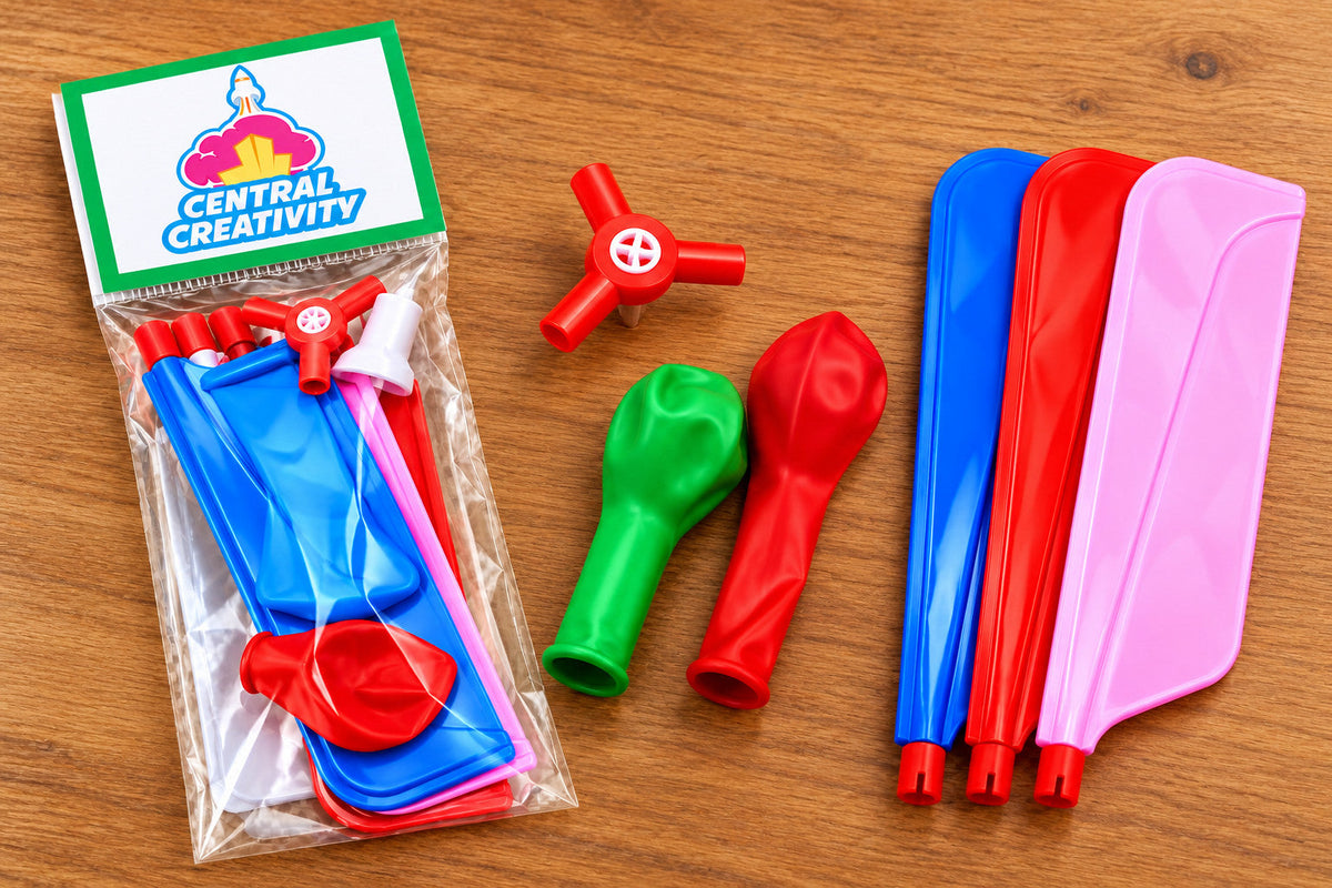 Everything in the kit laid out: a sealed bag of parts, the red rotor hub, two balloons and three rotor blades