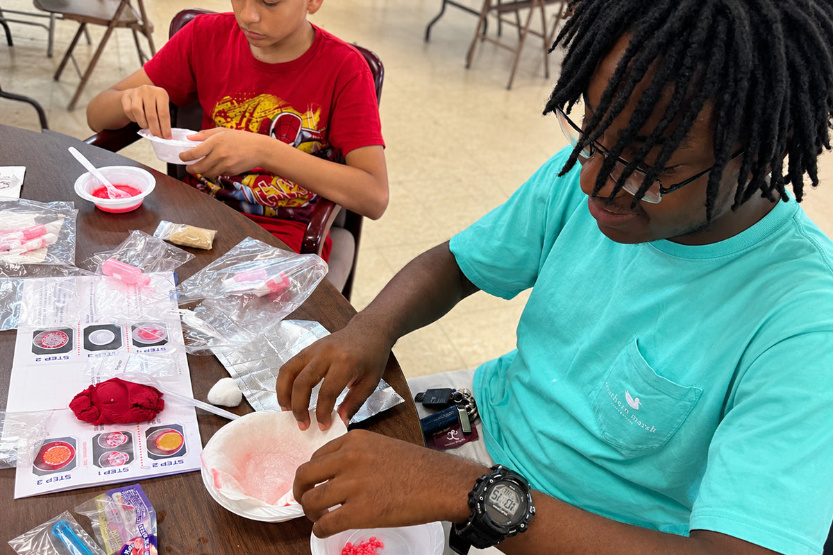 Her fourth graders running the oil spill activity. The photograph is in Drive: 1kYR3VJJLnhvMA5U9YascMWDfMcHNKcau
