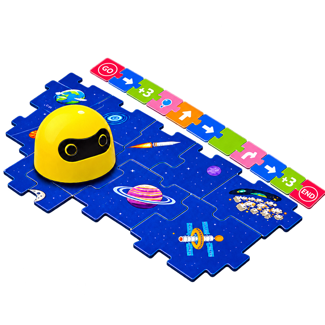 The yellow screen-free coding robot on its blue space themed floor mat, with a row of colored command tiles reading GO, turn, forward and END laid out beside it