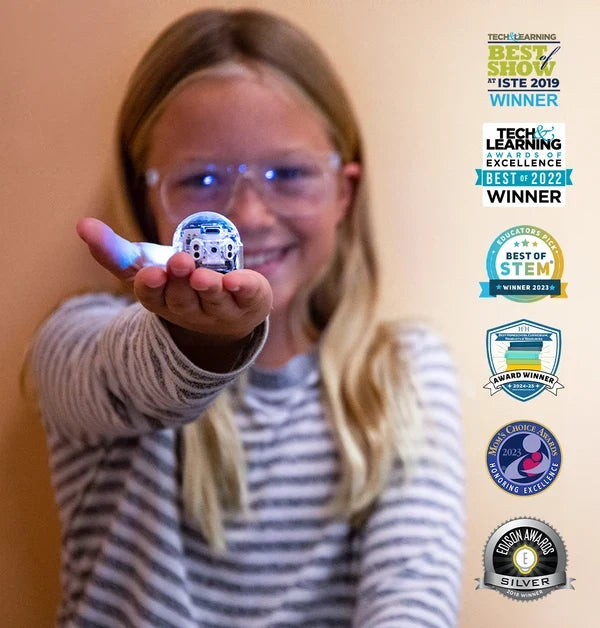 A child holding a lit-up Evo out on her palm, with a column of award badges alongside: Tech and Learning Best of Show at ISTE 2019, Tech and Learning Awards of Excellence Best of 2022, Educators Pick Best of STEM Winner 2023, an Award Winner badge for 2024 to 25, Mom's Choice Awards 2023, and Edison Awards Silver.