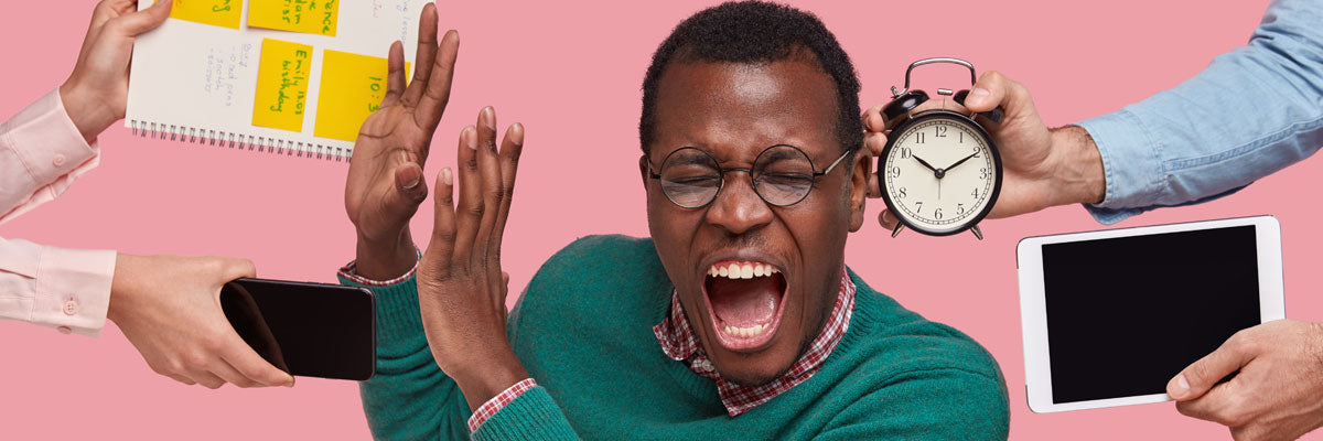 A teacher throws up his hands, overwhelmed, as hands reach in from every direction pushing a notebook, a phone, a tablet and an alarm clock at him.