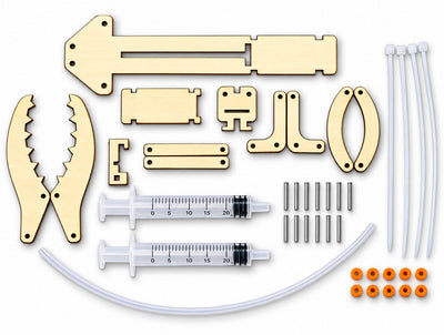 Everything in the kit laid out: laser-cut wooden parts, two syringes, clear hose, metal shafts, orange fixing rings and zip ties