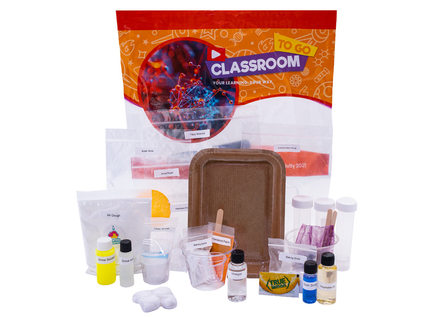 An orange Classroom TO GO physical science unit bag with its individually labeled activity bags and pre-measured materials laid out