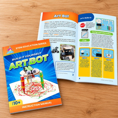 The eight-page Art Bot instruction manual, one copy closed and another open to the Mars rover background page and the first three build steps.