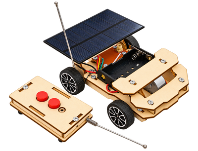 The assembled solar car and its wooden remote control, the solar panel on the roof and both antennas extended