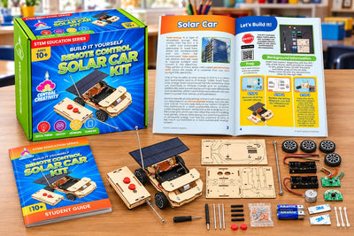 The Solar Car kit on a classroom desk: the box, the student guide open to the build pages, the finished car and every part laid out beside it