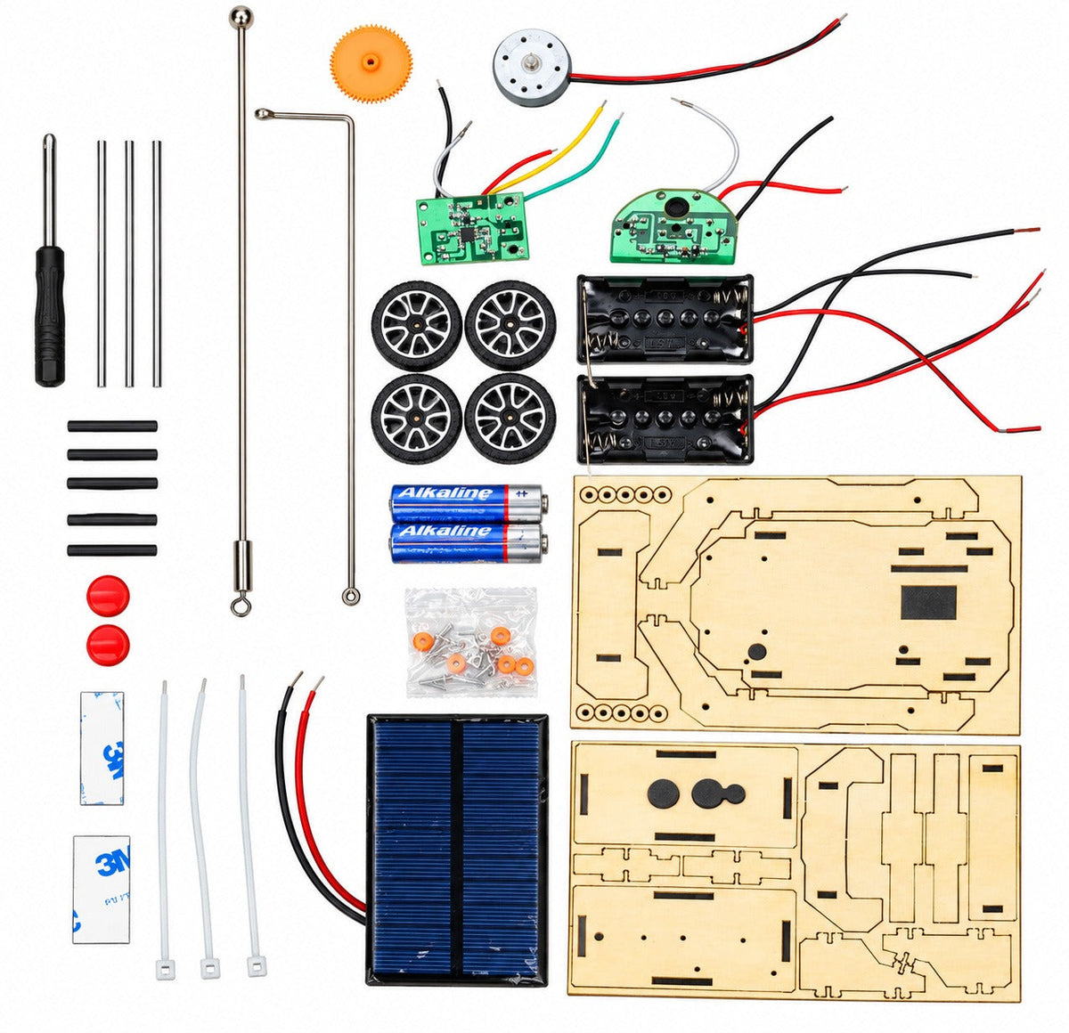 Everything in the Solar Car kit laid out: screwdriver, axles, wheels, motor, two circuit boards, two battery cases, AA batteries, the solar panel, screws and the laser-cut wooden boards