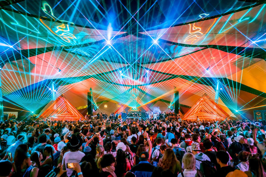 A laser light show projecting beams and patterns over a crowd
