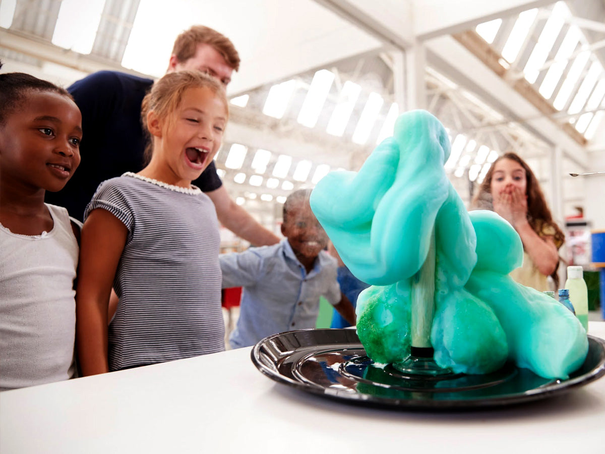 A STEM event station with a queue of families